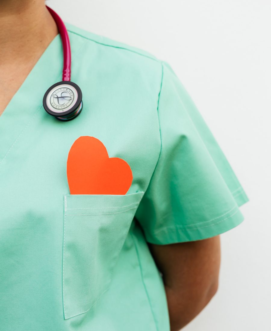 A nurse-writer in scrubs with a stethoscope